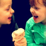 Two kids enjoying ice cream together
