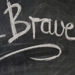 "Be Brave" written on a chalkboard.