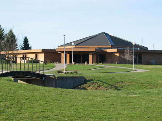 Photo of UCA church & front lawn in summer